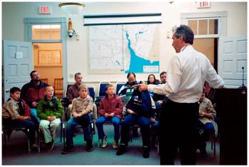 BELFAST - Belfast City Manager Joe Slocum gives members of Boy Scout Troop 30 a crash course on municipal government during a visit to City Hall. "I gave them each 10 pennies. They didn't like putting them in the hat," he said after the scouts left, "They picked up on it just like that."
