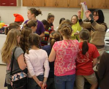 family-and-consumer science teacher Sue Burwell gives instructions to students gathered around the candy cart. (Photo by Holly S. Edwards)
