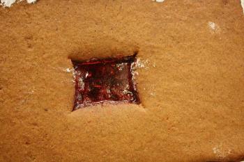 Prior to baking the gingerbread, some students dropped Jolly Rancher candies in holes cut for windows to create a stained glass effect. (Photo by Holly S. Edwards)