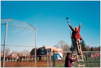 BELFAST - Peter Wilkenson directs opponents of a planned propane terminal in Searsport. Using a camera mounted on a pole, he photographed the protesters joining hands in a circle the diameter of the 22.7 million gallon storage tank that would be part of the development.