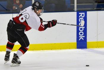 Camden Hills Jack Orner send the puck towards the Hampden goal Satturday. (Photo by Ron Hawkes)