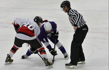 Camden Hills Stephen Hand wins a face off. (Photo by Ron Hawkes)