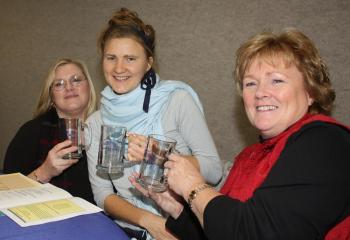 From left, 2012 Hutchinson Center scholarship recipients Dayne Beckett of Belfast, Birgitta Polson of Lincolnville and Tami Miles of Waldo are all smiles with their new glass UMaine steins during the scholarship luncheon Dec. 14. (Photo by Holly S. Edwards)