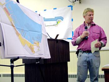 Front Street Shipyard President JB Turner, addressing the City Council on Tuesday night, describes a proposal to expand the company's waterfront complex in order to accomodate larger vessels. The plan would add a new mobile boat lift, a leg to an existing pier and a massive new building that would be the largest on the property. (Photo by Ethan Andrews)