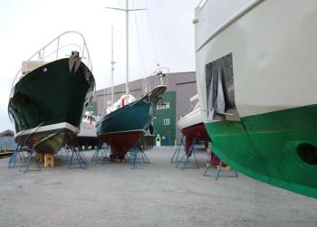 Front Street Shipyard has managed small boats like these with ease but is looking for headroom with a new proposal that gets its first official airing tonight. Two of three versions of the plan, which would include the largest building to date, a new mobile boat lift and pier, involve using city land. (Photo by Ethan Andrews)