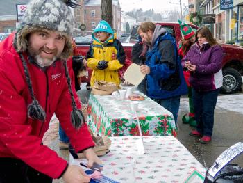 Parks and Recreation Commission members, from left, Chip Curry, Cathy Gleeson and Robert Gordon give out roasted chestnuts and cider at the annual Old Fashioned Christmas in downtown Belfast Dec. 1, more two months after the volunteer group lost its full-time director. (Photo by Ethan Andrews)