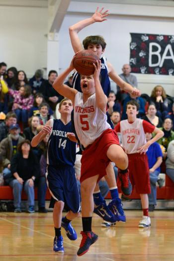 Vinalhaven's Max Stanley, front, goes up for a layup with Woolwich's Dakota Freeman coming up from behind. (Photo by Ron Hawkes)