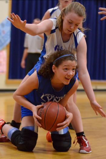 Lincolnville's Tora Decker-Griffith looks to pass the ball as Hope's Kelsie Merrill plays defense from behind her. (Photo by Ron Hawkes)