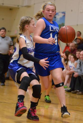 Lincolnville's Mya Wiley drives up the floor as Hope's Laticia Billings plays tough defense. (Photo by Ron Hawkes)