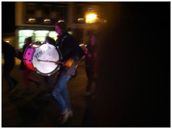 Eric Sanders anchors the beat for a pick-up ensemble of a hundred spoons, bottles and pans marching down Main Street just before midnight. (Photo by Ethan Andrews)