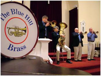 The Blue Hill Brass Band at the First Baptist Church several minutes before making a joke about their band not having a drum. (Photo by Ethan Andrews)