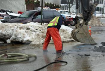 A Maine Water employee uses a jackhammer on Union Street, in front of Camden Exxon, to work on a major water main break discovered Sunday morning in front of Camden Exxon. (Photo by Holly S. Edwards)
