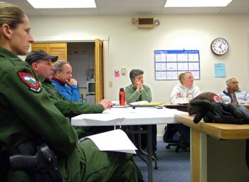Representatives of the Maine Department of Inland Fisheries and Wildlife, from left, game wardens Michelle Merrifield and Mark Merrifield and IFW biologist Keel Kemper meet with members of the Islesboro Deer Reduction Committee, Jan. 3. (Photo by Ethan Andrews) Representatives of the Maine Department of Inland Fisheries and Wildlife meet with members of the Islesboro Deer Reduction Committee
