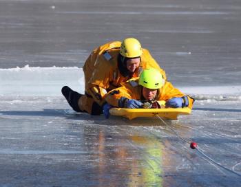 With the victim out of the water, he and one of the rescuers are pulled to safety on shore. (Photo by Holly S. Edwards)