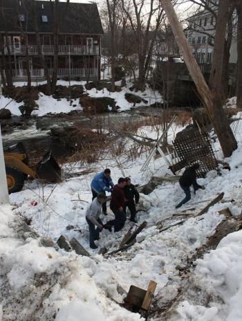 Co-workers and CFAA EMTs assist Tracy Harford as they begin to make their way up the embankment in Camden Friday afternoon. (Photo by Holly S. Edwards)