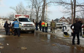 Tracy Harford is taken to a Camden First Aid Association ambulance after going over an embankment at the Knox Mill parking lot. (Photo by Holly S. Edwards)