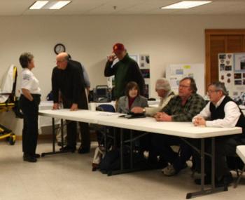 CFAA EMS Chief Julia Libby talks to Camden Select Board member Jim Heard, at a table with Leonard Lookner, Camden Town Manager Pat Finnigan, Don White, John French and Martin Cates. (Photo by Holly S. Edwards)