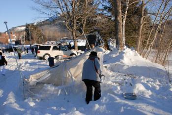 Despite losing their tent overnight, the Camden Real Estate crew rallied, dug out and set up in time to sell baked goods for Habitat for Humanity. (Courtesy Snow Bowl/by Dave Ridley)