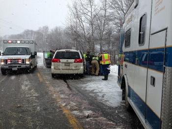 Emergency responders work to free an injured passenger. (Photo by Lynda Clancy)