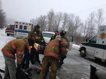 Firefighters pick up car parts off Route 17. (Photo by Lynda Clancy)