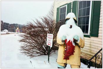 BELFAST - Behind a snow covered fisherman outside Perry's Nut House, the fisherman sign for the Jed's Restaurant is visible. Both local landmark properties are currently for sale. BELFAST - Behind a snow covered fisherman outside Perry's Nut House, the fisherman sign for the Jed's Restaurant is visible, at left. Both local landmark properties are currently for sale. (Photo by Ethan Andrews)