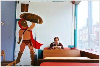 BELFAST - A partially-completed mural of a Spartan warrior at Alexia's Pizza painted by Maleah Chadwick of Searsmont . Owner Ted Rakis, who was born within a mile of the tomb of King Leonidas in Sparta, sits in his customary seat at the restaurant. BELFAST - A partially-completed mural of a Spartan warrior at Alexia's Pizza painted by Maleah Chadwick of Searsmont . Owner Ted Rakis, who was born within a mile of the tomb of King Leonidas in Sparta, sits in his customary seat at the restaurant. (Photo by Ethan Andrews)