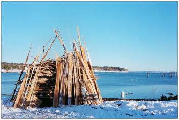 BELFAST - A construction of donated lumber erected at the public landing Dec. 31 in preparation for the 2012-13 New Year's Eve bonfire. BELFAST - A bundle of potential energy erected at the public landing Dec. 31 in preparation for the 2012-13 New Year's Eve bonfire. (Photo by Ethan Andrews)