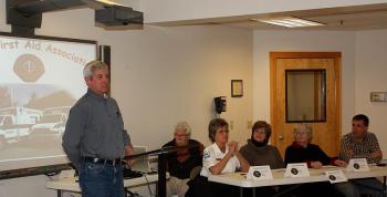Steve Corson, chairman of the Camden First Aid Association Board of Directors, talks to selectmen, town managers and others from Camden, Rockport, Lincolnville and Hope Wednesday night. Also pictured, from left, CFAA paramedic Bill Bentley, EMS Chief Julia Libby, board member and Deputy EMS Chief Julie Allen, and board members Ramona Graves and Chris Sewall. (Photo by Holly S. Edwards)