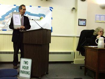 City Manager Joe Slocum shows a parking sign on which a paper lists new hours for downtown, daytime parking. The Council signed off on the signage (actual lettering would appear larger) during a meeting that featured a wide range of topics, from Front Street Shipyard to the Harbor Walk and RSU 20 Withdrawal. (Photo by Ethan Andrews) City Manager Joe Slocum shows a parking sign on which a piece of paper lists new hours for downtown, daytime parking. (Photo by Ethan Andrews)