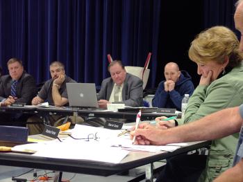 RSU 20 board member Sharon Catus, far right, pauses during emotion-filled comments to the board about the proposed reorganization of her town's elementary school. (Photo by Ethan Andrews)