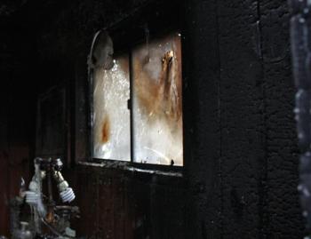 Charred walls and smoke-smudged windows inside the burned home on Marrs Hill Road. (Photo by Holly S. Edwards)