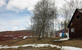 The home that burned overnight Friday, belonging to Barbara and John F. Worden, was tucked up next to a blueberry barren at the end of Marrs Hill Road in Union. (Photo by Holly S. Edwards)