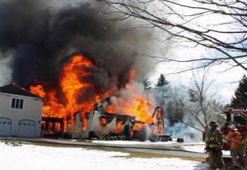 Two minutes after the first engines arrived on scene the roof and second floor collapsed into the first floor. (Photo by Holly S. Edwards)