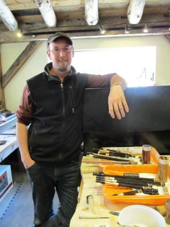 Musician and craftsman Chris Pinchbeck stands in his new shop, which he built using timbers from the property's 1820s Colonial farmhouse. (Photo by Kay Stephens)