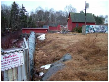 Looking south from Mill Dam. The Goose River Hydro office, formerly of the Sherman & Co. leatherboard mill, is the red building visible at right. (Photo by Ethan Andrews)