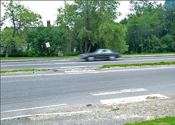 Crossing Route 1 at Route 141 in Belfast was famously risky undertaking before 2009 when the city began a series of improvements aimed at slowing traffic and making safer crossings. The original crosswalk, since relocated, is pictured here. A second round of improvements is in the works. (Photo by Ethan Andrews) Crossing Route 1 at Route 141