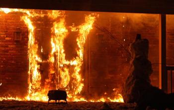 A snowman, built by Lincolnville firefighters Brandon Allen, Orin Todd and Nathaniel Boehmer, following training evolutions Sunday afternoon, appears to be waving goodbye to the former Lotus Restaurant on Route 1 in Camden as it burns to the ground at the request of property owner Hannaford Supermarkets. (Photo by Holly S. Edwards)
