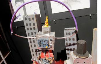 Jalina "Jolly" Brown on the whimsical cardboard robots tearing apart a city she made for an art project. “I just create random weird things that come out of my brain,” she said. (Photo by Kay Stephens)