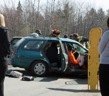 Melissa Parker of Lincolnville waits to be removed from the Ford Escort Monday afternoon. (Photo by Holly S. Edwards)