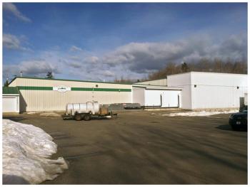 A 21,000 square foot addition planned for Ducktrap River of Maine's Belfast operations would cover the facility's existing east parking, shown here, along with a smaller area on the north side of the building. (Photo by Ethan Andrews)