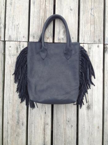 A subtle reminder of the '70s, this is her soft black leather tote bag with fringe. Courtesy Erin Little