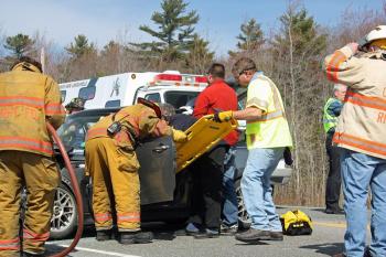 Rescuers work to remove the injured driver of the Mini Cooper, Thomas Tarbox of Camden. (Photo by Holly S. Edwards)