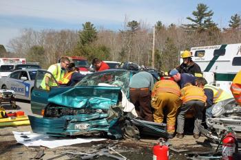 The injured driver of the Ford Escort station wagon, Terry Ripley, is removed from the car. (Photo by Holly S. Edwards)