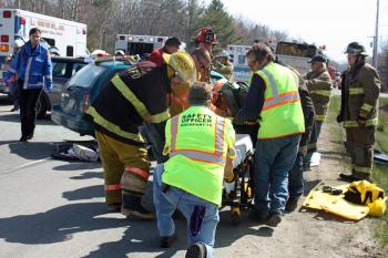 Melissa Parker is removed from the station wagon and placed on a stretcher. (Photo by Holly S. Edwards)