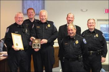 From left, Rockland Police Officer James Jillson is joined by Sgt. Ken Smith (back), Chief Bruce Boucher, CID Sgt. Chris Young (back), Deputy Chief Wally Tower and Sgt. Tony Camporiale after accepting the city's commendation for 33 years of service. (Photo by Chris Wolf)
