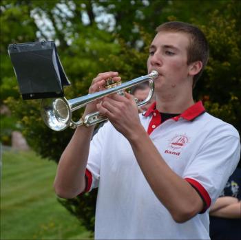 Camden Hills Regional High School band member John Hall plays taps in Rockport Memorial Day. (Photo by Lynda Clancy)