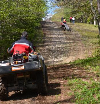 Heading up Ragged Mountain with tools, ladders and workers.