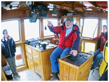 Capt. John Worth aboard one of four tugboats operated by the Penobscot Bay Tractor Tug Co. The Belfast-based subsidiary of Fournier Tugs primarily guides cargo ships and other large vessels in and out of ports in Penobscot Bay. (Photo by Ethan Andrews)