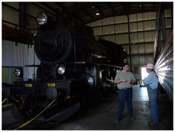 Joe Feero, left of Brooks Preservation Society talks with Tom Falicon of the Great Smoky Mountains Railroad. Behind them, a Swedish made locomotive that was a later addition to the B&ML. (Photo by Ethan Andrews)