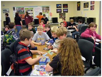 Students socialize and start impromptu games in the general meeting room before splitting off to nearby classrooms designated for certain games. (Photo by Ethan Andrews)